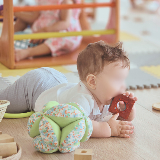 bebé boca abajo explorando materiales en ambiente preparado