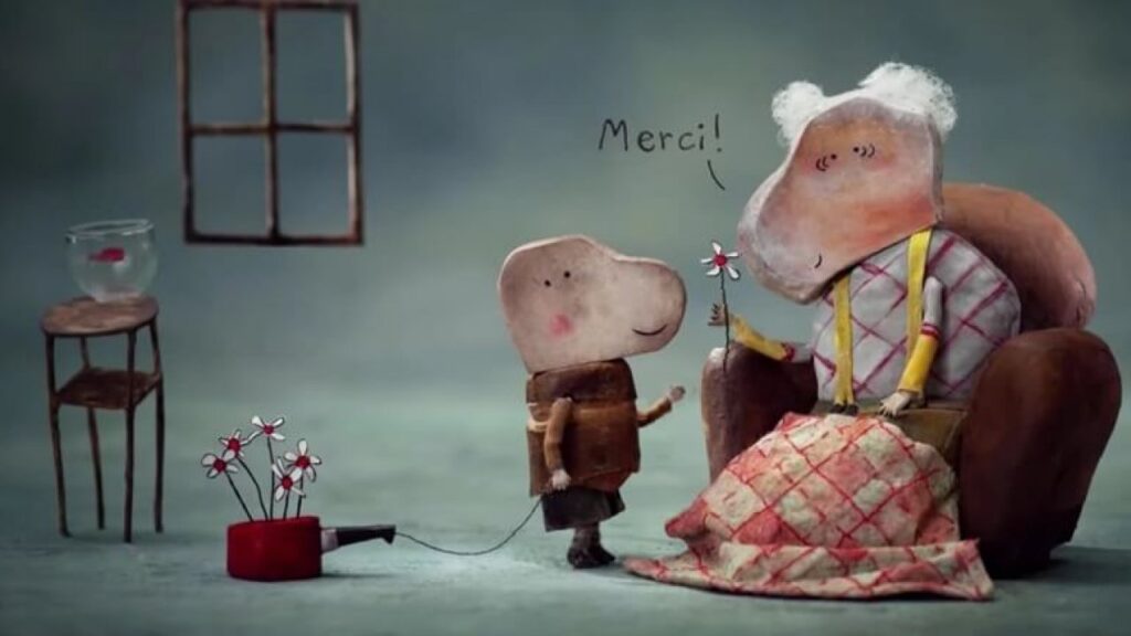 Fotograma del cortometraje animado La petite casserole d’Anatole donde el niño arrastra su pequeña cacerola roja.