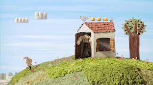 Escena del cortometraje stop motion The Kite con un niño y su abuelo volando una cometa.